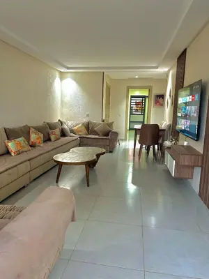 a living room with a couch and a table at Residence Bleu Dhalia in Sidi Rahal