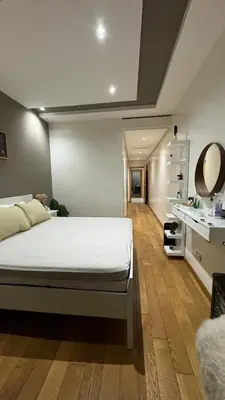 a bedroom with a large white bed and a bathroom at Jnane californie in Casablanca