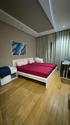 a bedroom with a large bed with purple sheets at Jnane californie in Casablanca