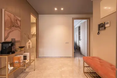 a living room with a couch and a hallway at Studio 1BR Near CFC - 5 Stars Experience in LʼOasis