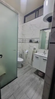 a bathroom with a sink and a toilet and a mirror at Appartement Meublé avec Parking Gratuit, Calme & Pratique à Casablanca in Aïn Sebaa
