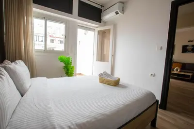 a white bed in a room with a window at Duplex au centre de Rabat in Rabat