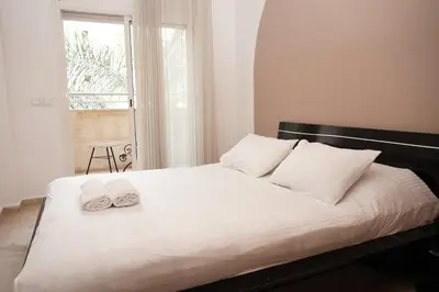 a bedroom with a bed with two towels on it at Cosy Loft - 2 Bedrooms & Parking - Agdal Center in Rabat