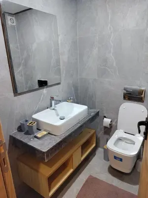 a bathroom with a sink and a toilet and a mirror at Beautiful apartment 2 bedrooms living room aéroport mohamed 5 nouaceur Casablanca in Casablanca