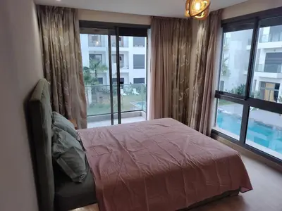 a bedroom with a bed and a large window at Beautiful apartment 2 bedrooms living room aéroport mohamed 5 nouaceur Casablanca in Casablanca