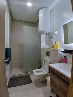 a bathroom with a toilet and a sink and a shower at Très beau studio Océan Park in Aïn Harrouda