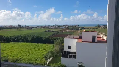 an aerial view of a white building and a green field at Ocean View Tamaris in Tamaris