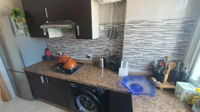 a kitchen with a sink and a stove and a counter at Ocean View Tamaris in Tamaris