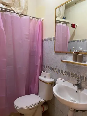 a bathroom with a toilet and a sink and a mirror at Bedroom for girls only in Casablanca