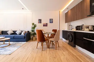 a kitchen and living room with a table and chairs at Chic blue studio au cœur deCasablanca in Casablanca