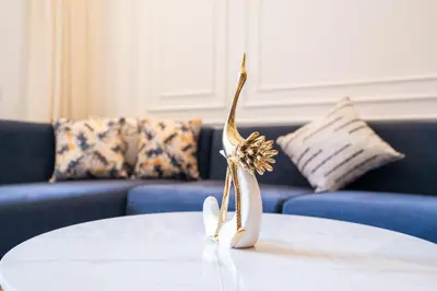 a white table with a gold trophy on top of it at Chic blue studio au cœur deCasablanca in Casablanca