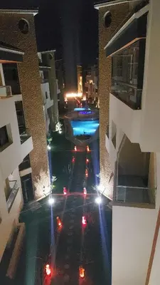 an overhead view of a swimming pool at night at Macha allah in Bouznika
