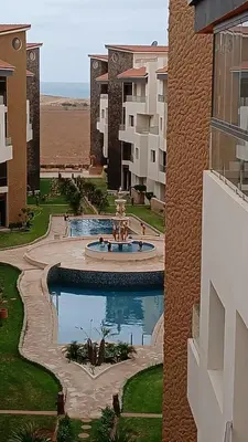 a view of a courtyard of a building with a fountain at Macha allah in Bouznika