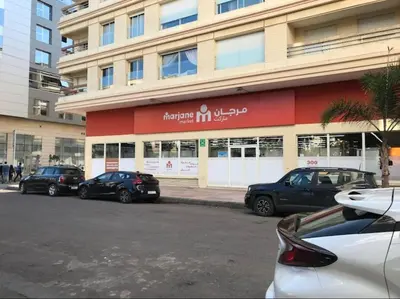 a group of cars parked in front of a building at Horizon Relax in Mohammedia
