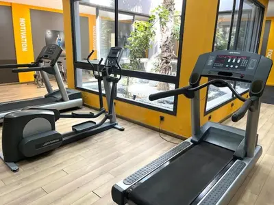 a gym with two tread machines and a treadmill at Appartement à louer in Nouaceur