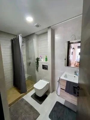 a bathroom with a toilet and a sink and a shower at Appartement à louer in Nouaceur