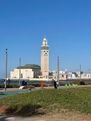 a large building with a clock tower in a city at Appartement élégant avec vue imprenable sur la corniche de Casablanca in Casablanca