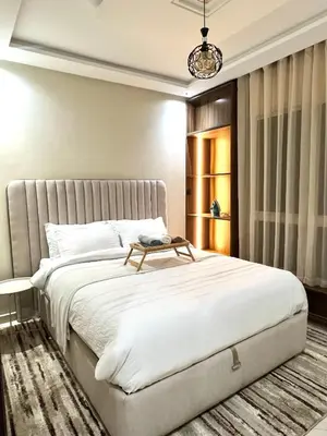 a bedroom with a large bed with a table on it at Appartement élégant avec vue imprenable sur la corniche de Casablanca in Casablanca
