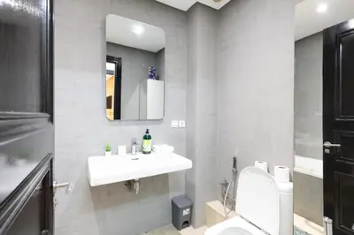 a bathroom with a sink and a toilet and a mirror at Appartement Luxueux pour Famille - Quartier Abdelmoumen in Casablanca