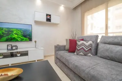 a living room with a couch and a tv at Mamounia Horizon in Casablanca