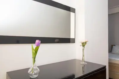 two vases with flowers on a table in a room at Mamounia Horizon in Casablanca