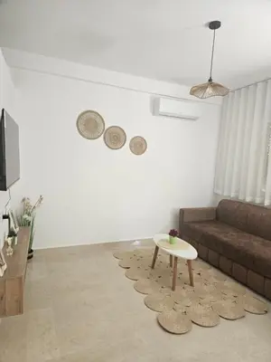 a living room with a couch and a coffee table at Apartamento Bonito in Rabat