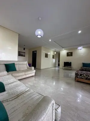 a large living room with couches and a couch at Beach flat with pool at Al Mansouria in O Ben Slimane