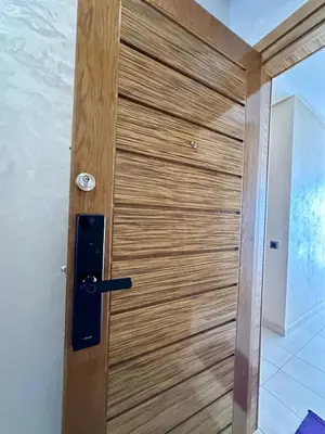 a wooden door with a handle in a room at Appartement Blanca Beach in Sidi Rahal