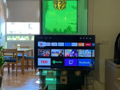 a flat screen tv sitting on top of a glass table at Beach palace 1 between sea pool and city center in Mohammedia