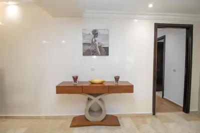 a table against a white wall with a bowl on it at Anfa Dream in Casablanca