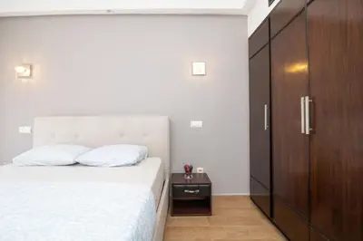 a bedroom with a white bed and a wooden cabinet at Anfa Dream in Casablanca