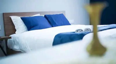 a bedroom with a bed with blue and white pillows at Luxe Bleu Studio Rabat in Rabat