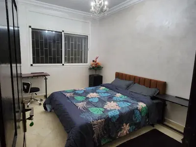 a bedroom with a bed and a desk and a window at Chambre pour une femme ou pour un couple dans un Appartement de luxe bien situé et bien équipé in Rabat