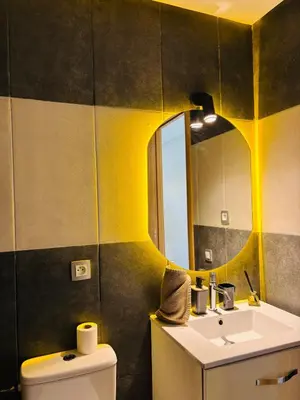 a bathroom with a sink and a mirror at Bright & Cozy Apt with City View in Casablanca