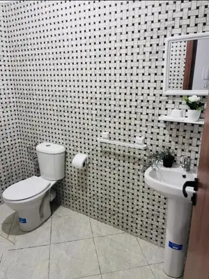 a bathroom with a toilet and a sink at A coté hôpital M6,Proche d'Aéroport et la gare bouskoura in Bouskoura