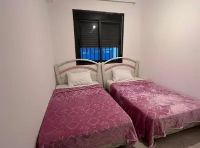 two beds sitting next to each other in a room at A coté hôpital M6,Proche d'Aéroport et la gare bouskoura in Bouskoura