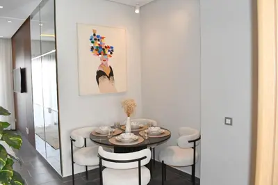 a dining room with a table and chairs at Elegant Apartment with City View in Casablanca