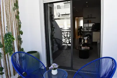 two blue chairs and a table in a room at Elegant Apartment with City View in Casablanca