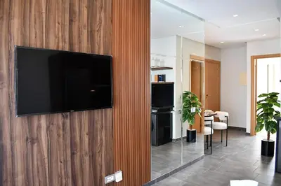 a living room with a television on a wooden wall at Elegant Apartment with City View in Casablanca