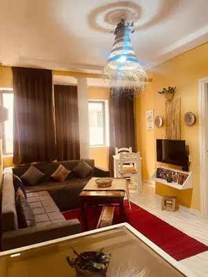 a living room with a couch and a chandelier at Sduisant Studio in Casablanca in Casablanca