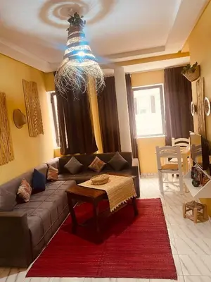 a living room with a couch and a chandelier at Sduisant Studio in Casablanca in Casablanca