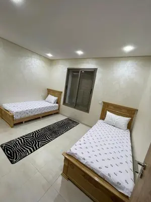 a bedroom with two beds and a window at Puerto Banus Appartement A4 in Mohammedia