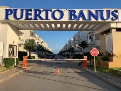 a sign over a street with a stop sign at Puerto Banus Appartement A4 in Mohammedia