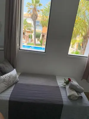 a bedroom with a large bed with a window at Villa oasis sidi rahal in Casablanca