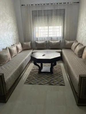 a living room with a couch with a coffee table at Charmant appartement pour votre séjour a Bouskoura a Casablanca in Bouskoura
