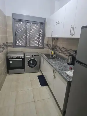 a small kitchen with a stove and a sink at Charmant appartement pour votre séjour a Bouskoura a Casablanca in Bouskoura