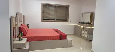 a bedroom with a bed and a dresser and a mirror at Luxe Suite au sein d'une villa in Rabat