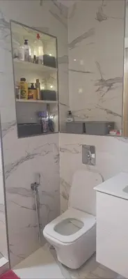 a white bathroom with a toilet and a sink at Luxe Suite au sein d'une villa in Rabat