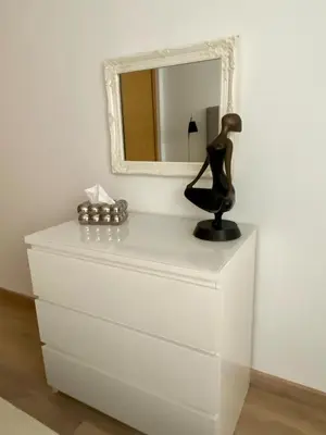 a dresser with a mirror and a statue on it at Le LOFT in Casablanca