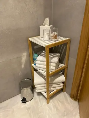 a wooden shelf with towels on it in a bathroom at Le LOFT in Casablanca